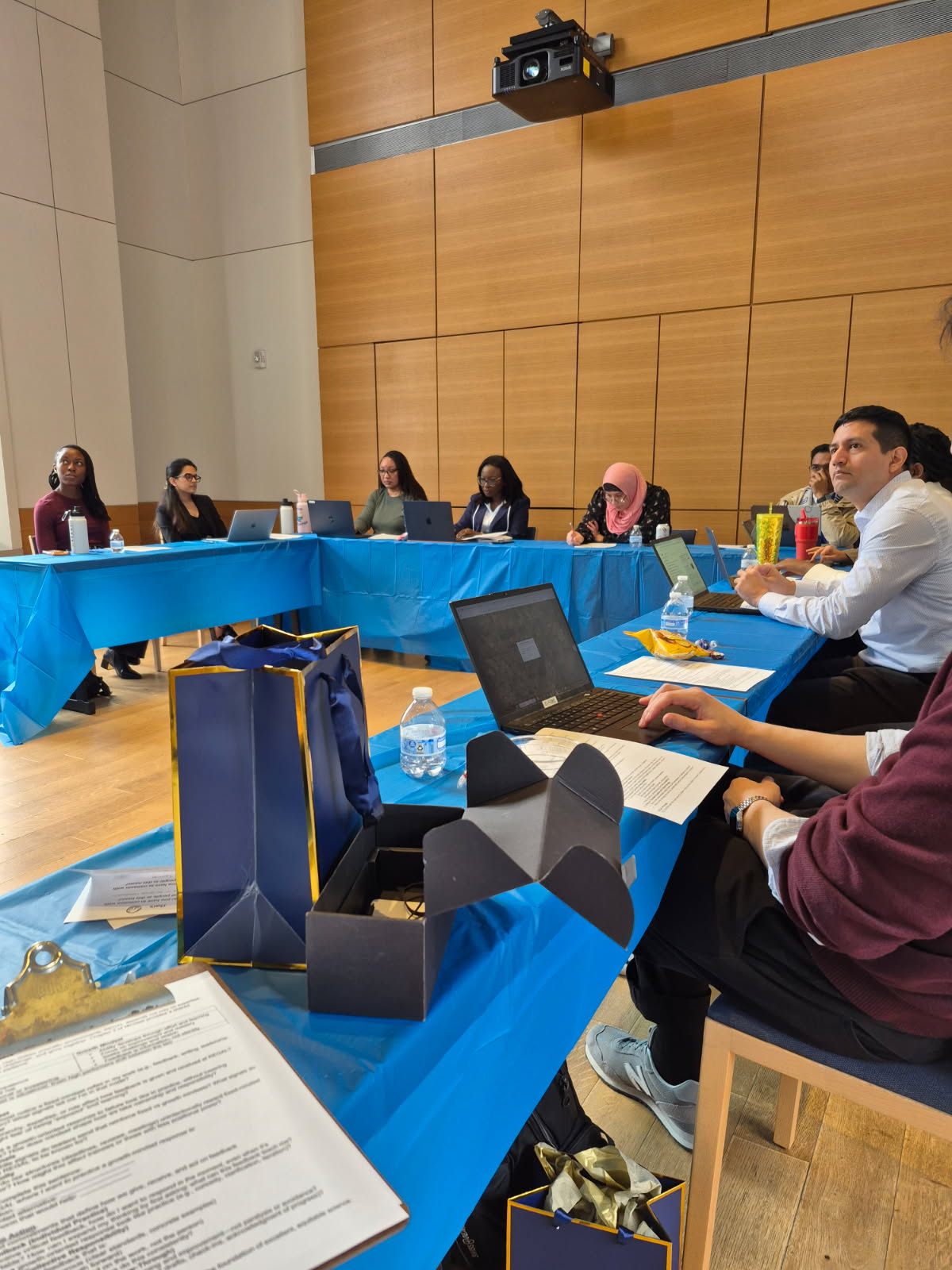 REGAL team members seated around tables with laptops during a retreat working session