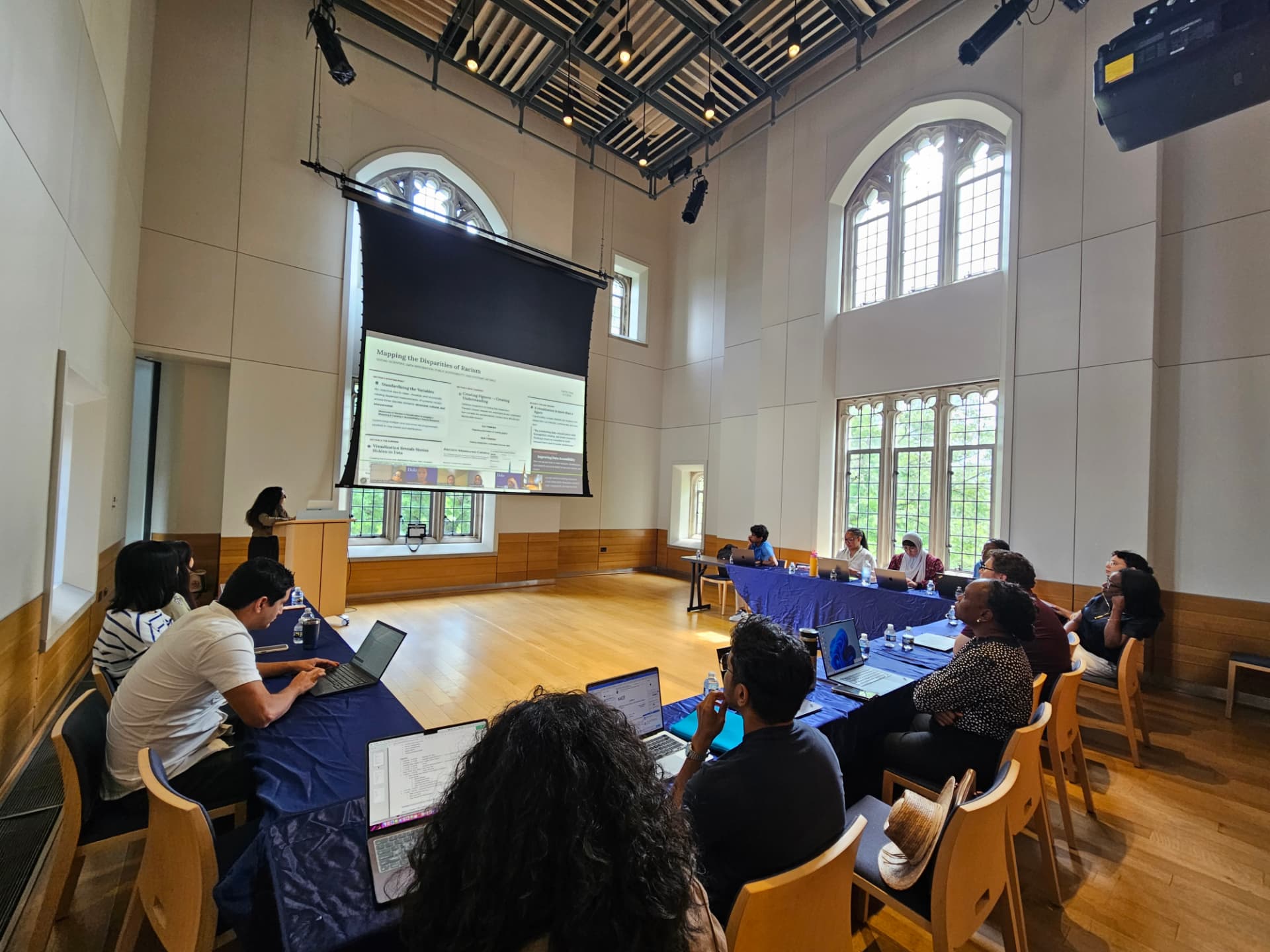 A presenter sharing a story about mapping racism and health disparities at the summer symposium