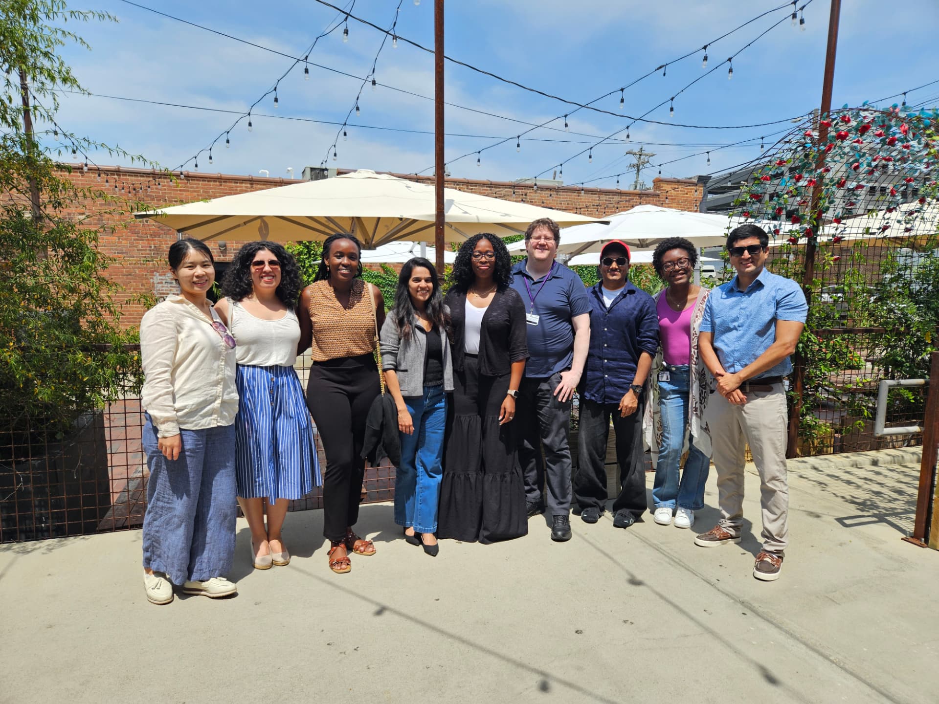The REGAL team gathered outdoors for a team lunch under string lights